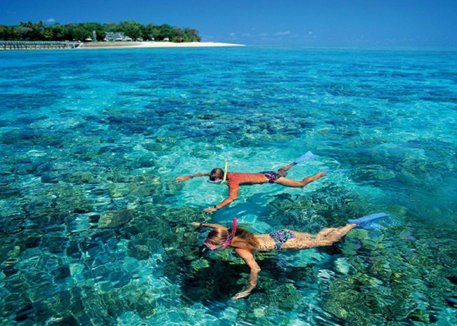 Bruce and his sister having a good time in the shallow waters of Cozumel.